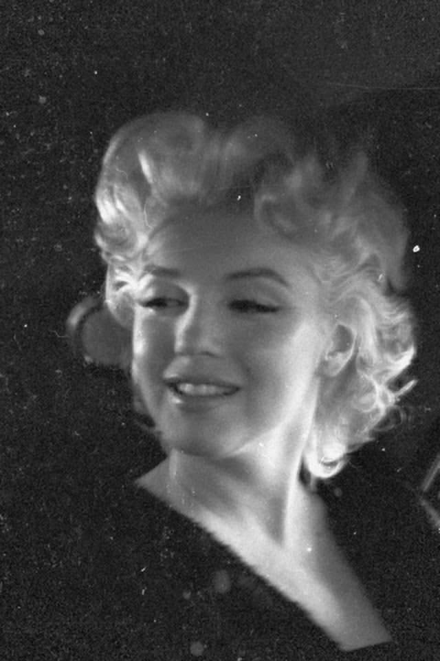 This photo of Marilyn is taken in the back of a car, 1955