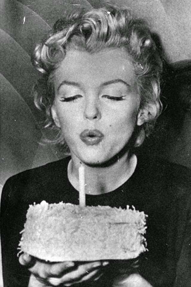 Marilyn blows out candles on her 30th birthday, 1956