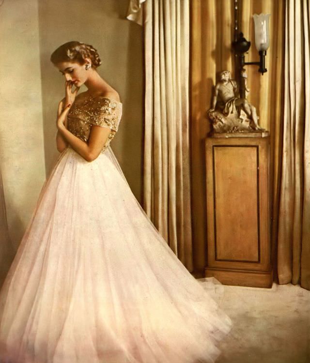 Carmen Dell' Orefice in delicate, drifting gown of tulle and iridescent embroidery from Elizabeth Arden Fashion Floor, 1951.