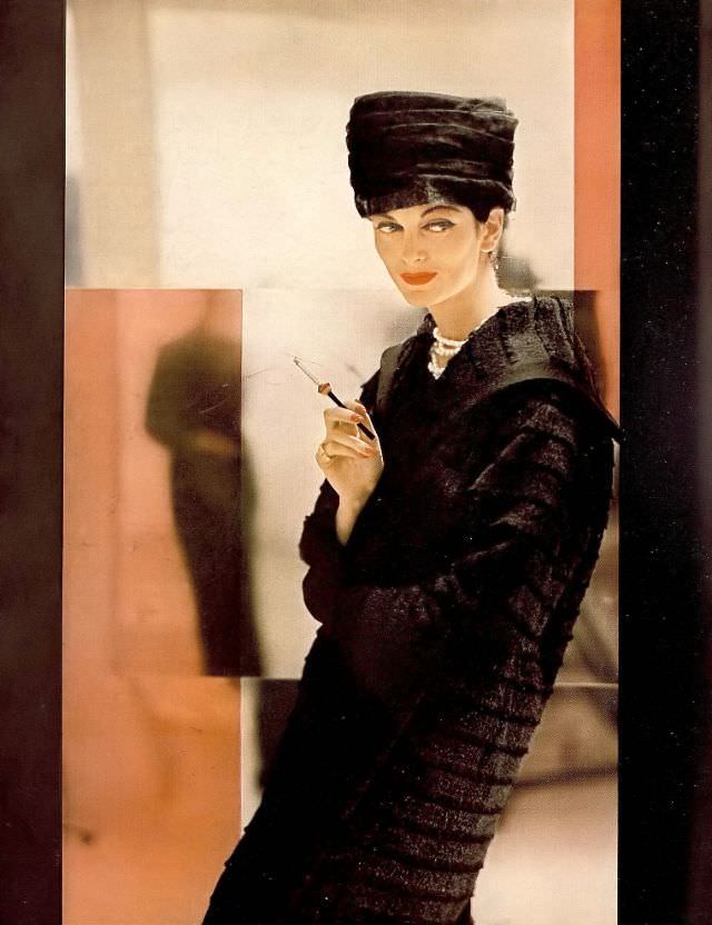 Carmen in coat of clipped layers of deep black wool woven with fur by Lilli Ann, fur toque by Mr. John, 1956.