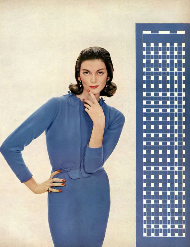 Carmen Dell' Orefice in soft blue cashmere cardigan scrolled in appliqué over a matching short-sleeved dress in thin blue wool by Vera Stewart, Harper's Bazaar, 1957.