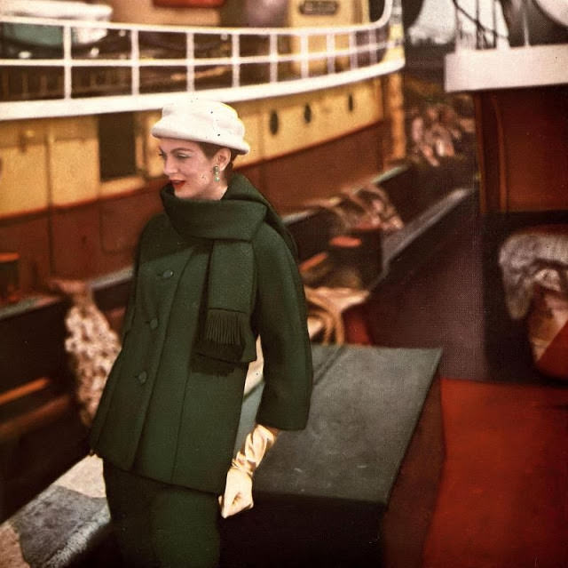 Carmen in deep green basket-weave wool suit with longer jacket and fringed scarf collar by Monte Sano & Pruzan, hat by Mr. Arnold, 1958.