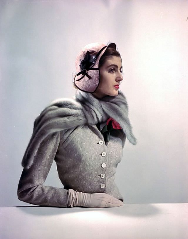 Carmen Dell' Orefice in dotted wool suit by Jane Derby, mink scarf by Fredrica, hat by Chanda, gloves by Aris, 1949.
