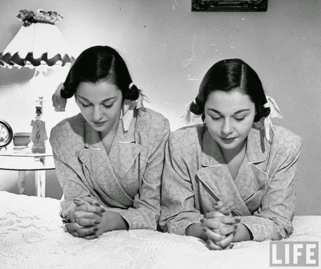 The O'Connor twins Gloria and Consuelo, praying before bed, 1947