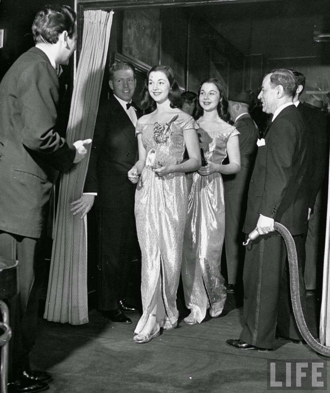 The O'Connor twins Gloria and Consuelo, entering night club, 1947