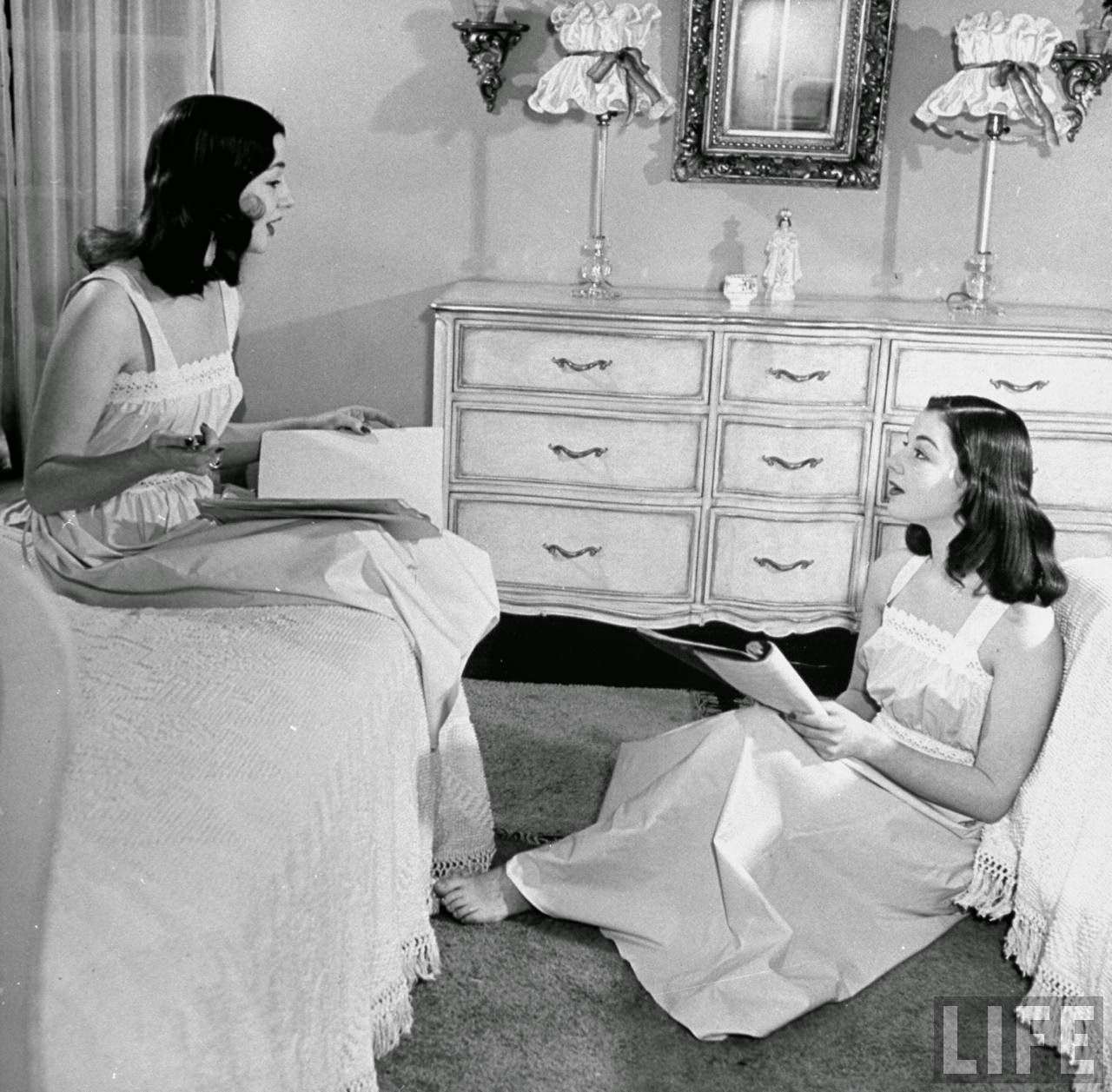 The O'Connor twins Gloria and Consuelo, sitting in bedroom, 1947