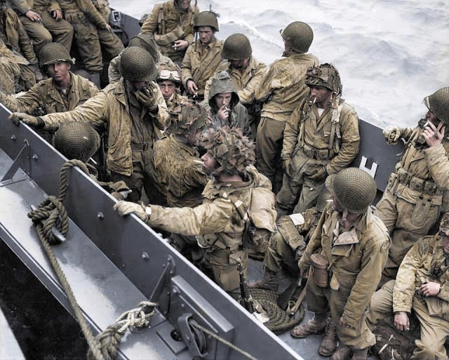 Glider pilots take the opportunity for a quick cigarette as they are crowded onto a landing craft.