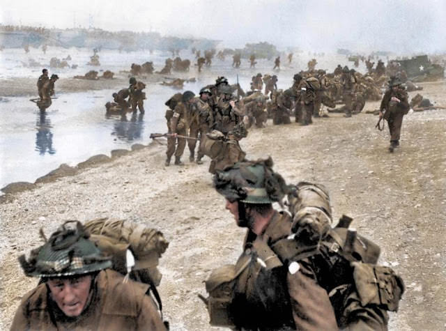 British troops show their true grit as they help injured comrades onto Sword Beach.