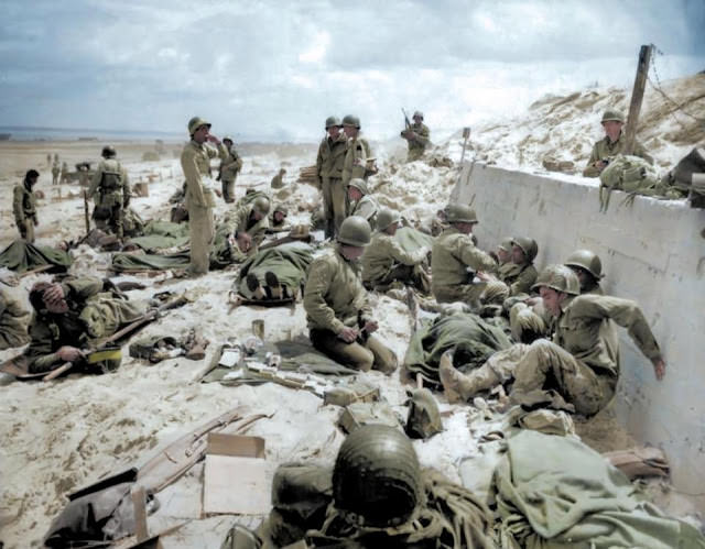 US Army Fourth Infantry Division troops take a breather after making their way onto Utah Red Beach.
