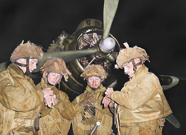 British Airborne Pathfinders check their watches on the night before the invasion.