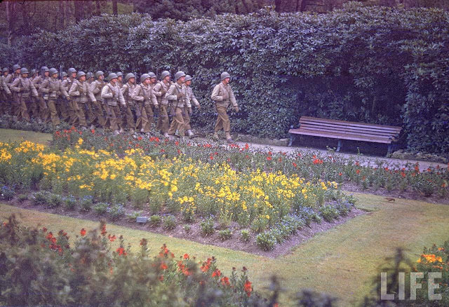 American infantrymen marching in an unident. park in England shortly before D-Day.