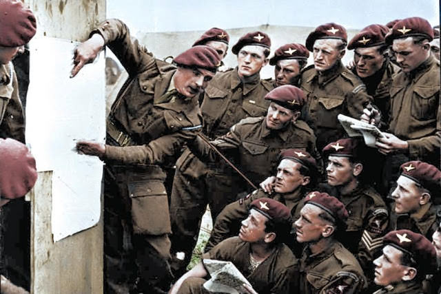 Members of the 22nd Independent Parachute Company, 6th Airborne Division attend a briefing ahead of the D-Day invasion.