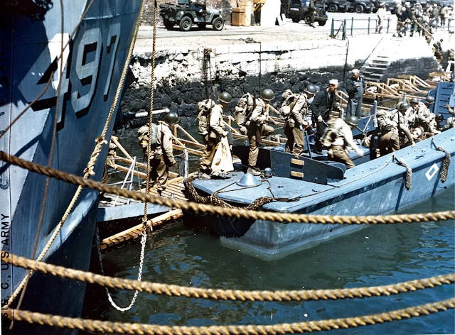 View of American troops as they board an LCVP (Landing Craft, Vehicle, Personnel), Weymouth, England, early June, 1944.
