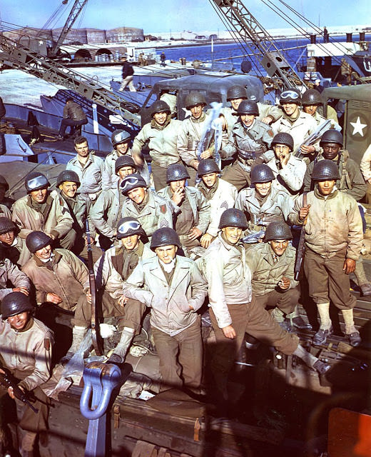 In England, American soldiers, having loaded their equipment and supplies onto an LCT (Landing Craft, Tank) await the signal to begin the D-Day invasion.