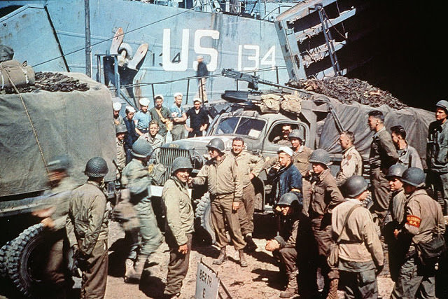 UTAH BEACH, FRANCE: US soldiers gather around trucks disembarking from landing crafts shortly after D-Day.