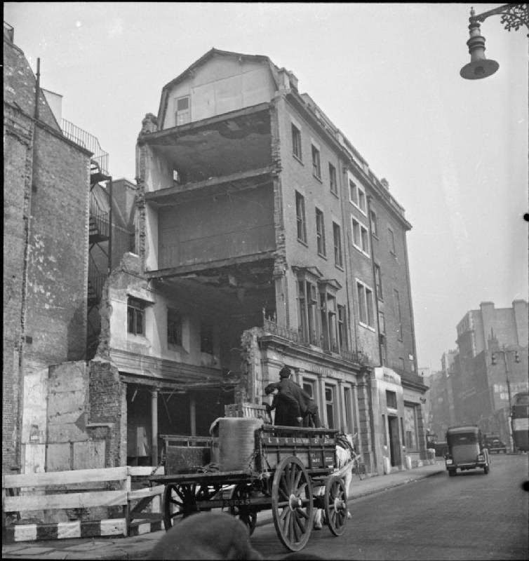 Lilian Carpenter and Vera Perkins drive their horse-drawn cart through London's West End on the way to their first delivery of the day, 1943.