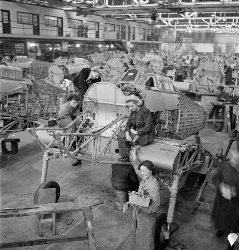 Hawker employees Winnie Bennett, Dolly Bennett, Florence Simpson and a colleague at work on the production of Hurricane fighter aircraft at a factory in Britain, in 1942.