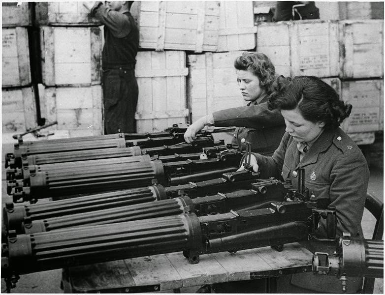 Water-cooled machine guns just arrived from the USA under lend-lease are checked at an ordnance depot in England, 1941.