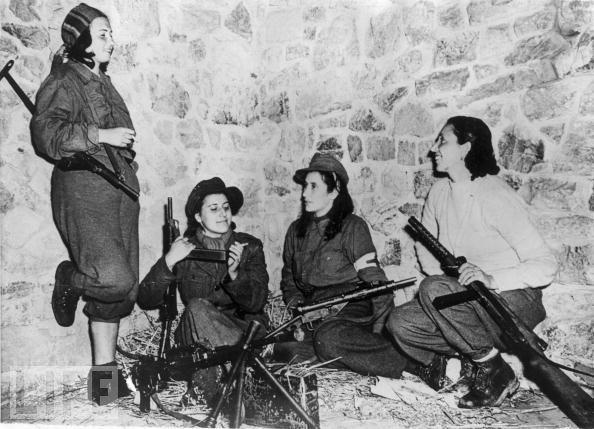 In November 1944, four female Italian anti-Fascist fighters relax as they await orders from their commander during their effort in support of Allied troops on the Castelluccio front.