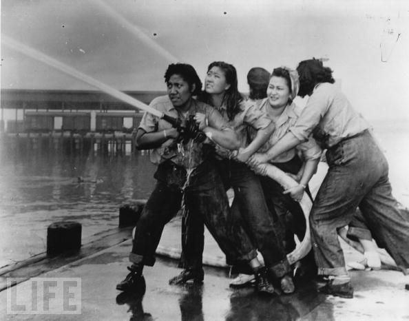 Women are on the front lines of World War II from day one, like these firefighters trying to contain the blaze during the Japanese attack on Pearl Harbor on December 7, 1941.