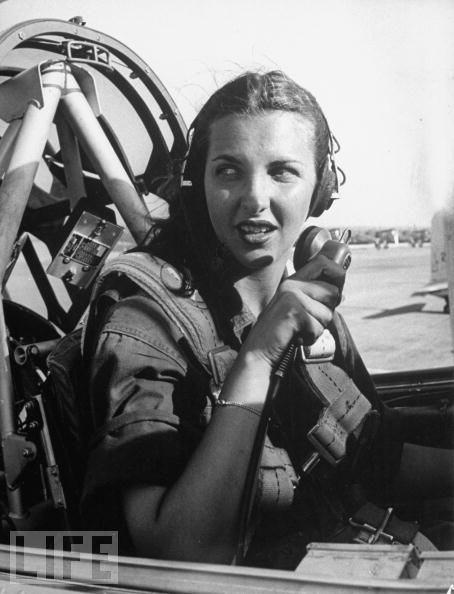 Nancy Nesbit, a pilot trainee in the Women's Flying Training Detachment checks with the control tower from the cockpit of her single engine Army trainer at Avenger Field in Texas.