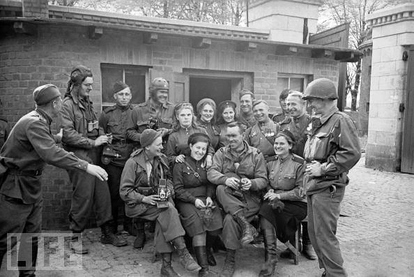 American soldiers and war correspondents join male and female Red Army soldiers in Torgau, Germany, on April 27, 1945, toward the end of the European war.