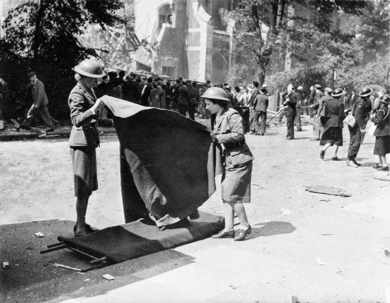 Women of the American Ambulance Great Britain prepare stretchers for casualties following a V1 attack in the Highland Road and Lunham Road area of Upper Norwood.