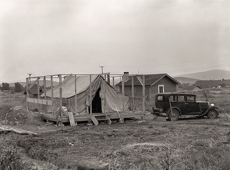 Family living in tent while building the house around them. Near Klamath Falls, Klamath county, Oregon