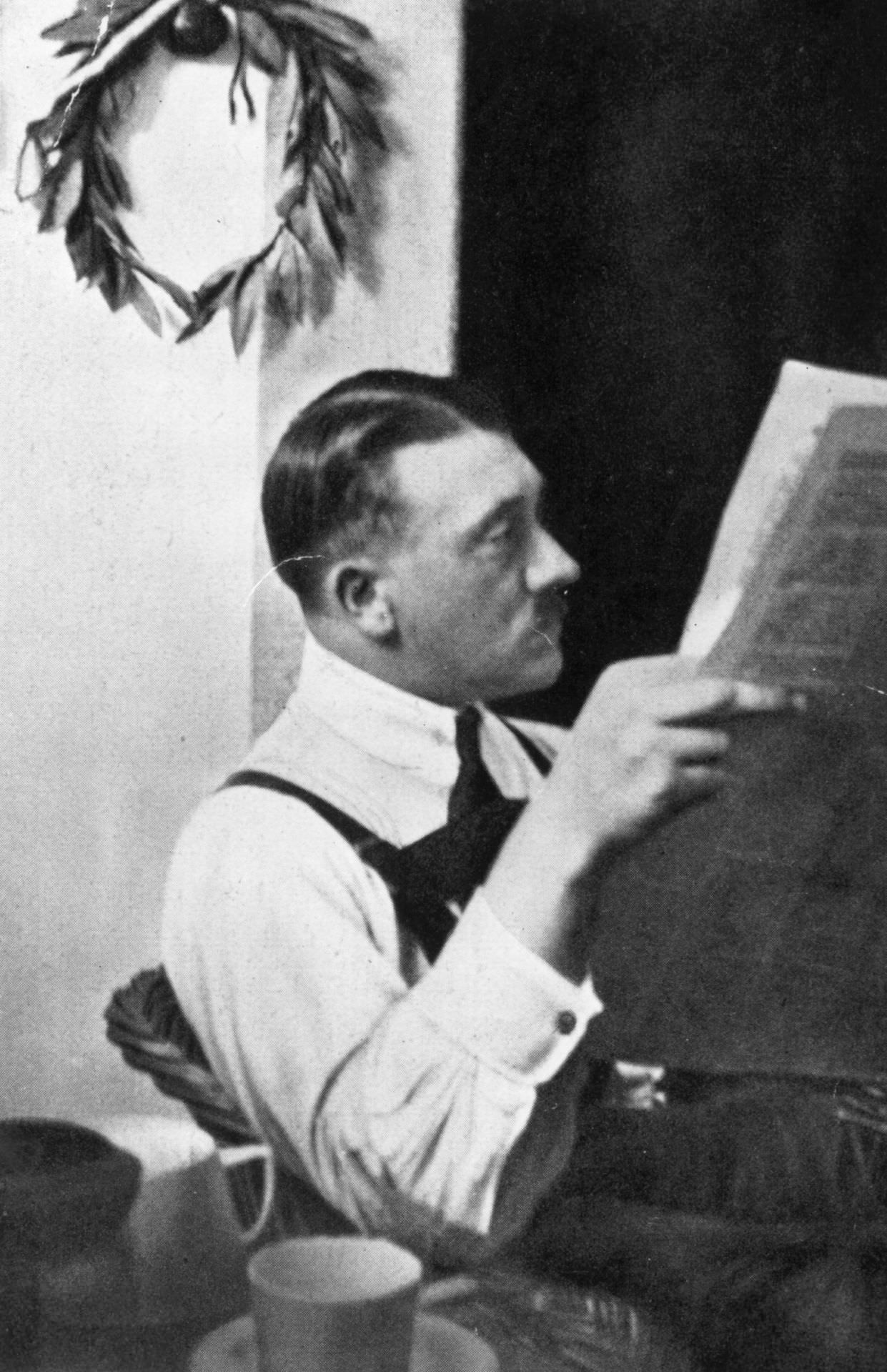 Adolf Hitler sits reading a paper during his imprisonment in Landsberg Jail, 1924