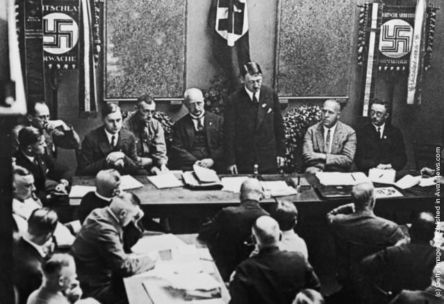 Adolf Hitler (standing, centre) at a party meeting in Munich, 1925