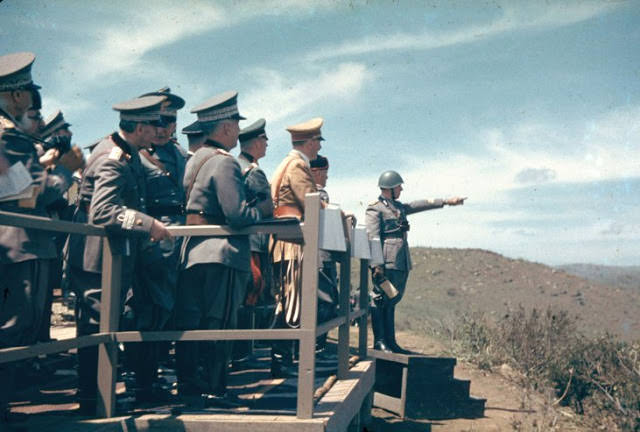 Adolf Hitler and Benito Mussolini observe Italian Army maneuvers during Hitler's 1938 state visit to Italy