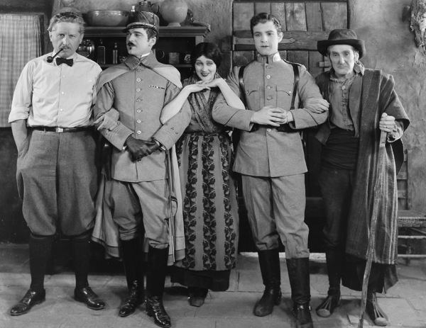 On the set of "Thy Name Is Women", 1924 with Fred Niblo and co-stars Wallace MacDonald, Ramon Novarro, and William V. Mong.
