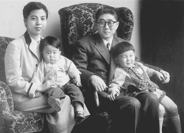 Japanese Prime Minister Shinzo Abe as a child, left, with his family in 1956