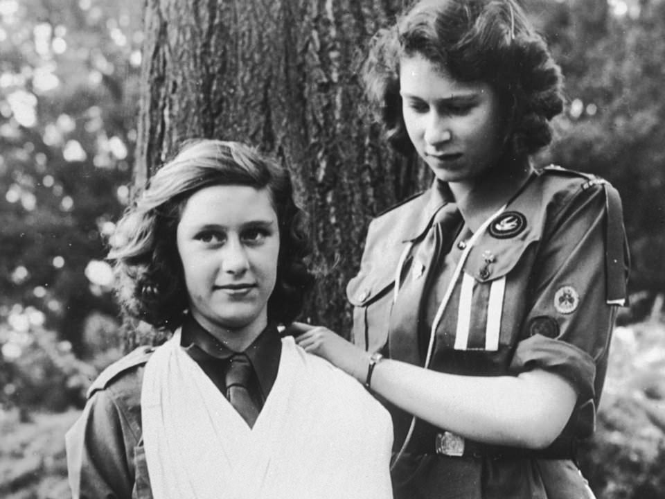 Queen Elizabeth II, right, practices bandaging with her sister, Margaret, 1943