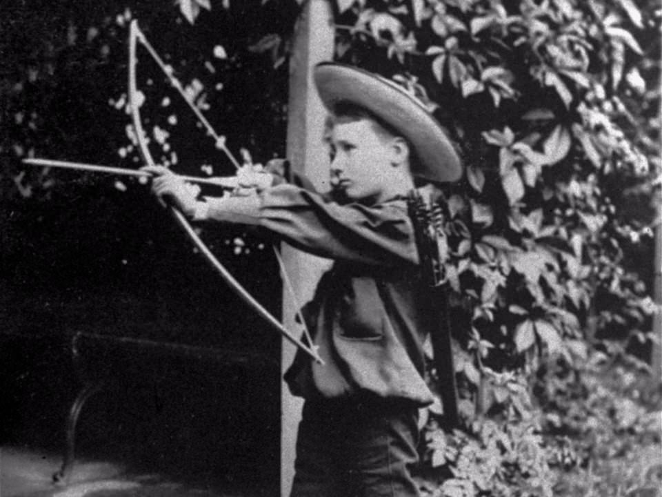 Franklin D. Roosevelt with a bow and arrow, 1890