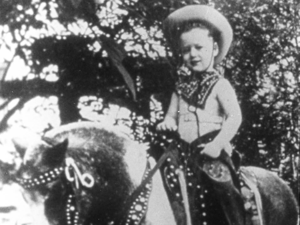 Former US President Bill Clinton on a pony near his childhood home in Arkansas