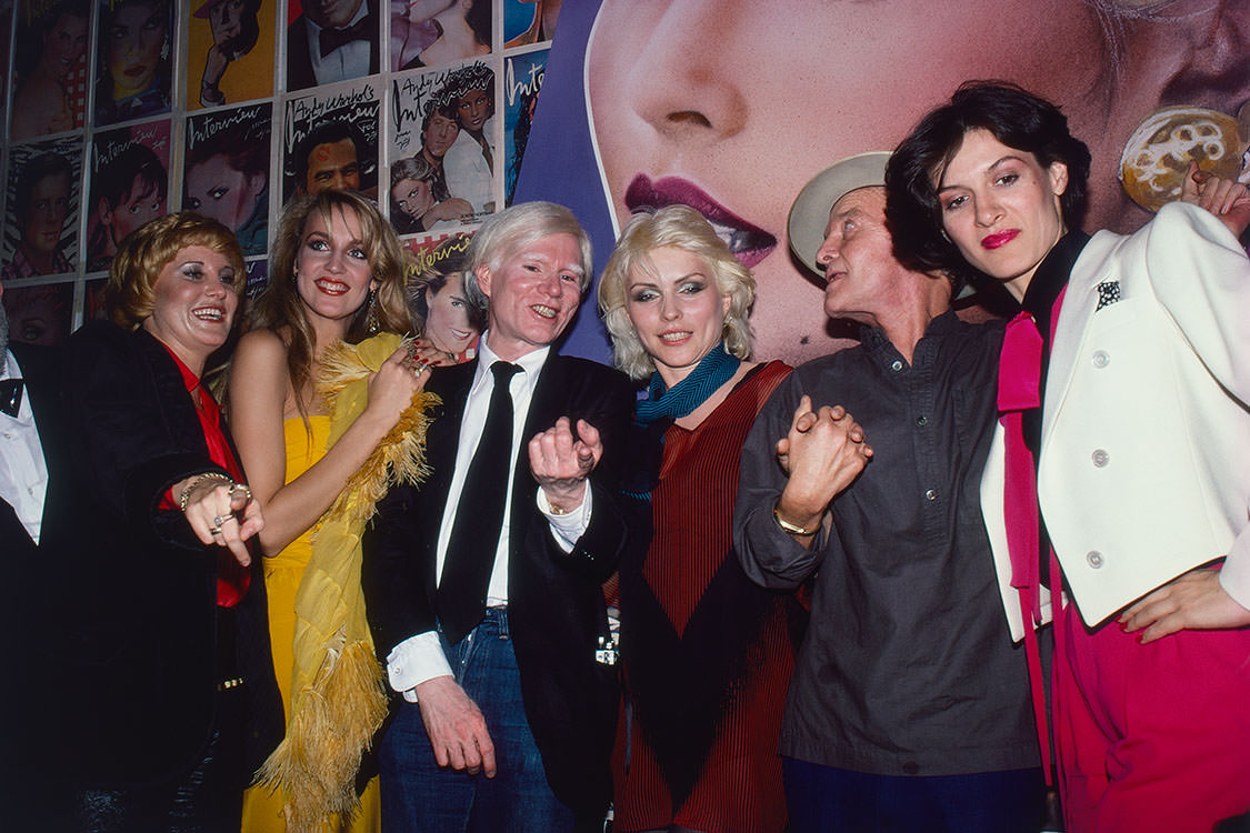 Jerry Hall with artist Andy Warhol, singer and songwriter Debbie Harry, novelist Truman and Paloma Picasso in New York City, 1979