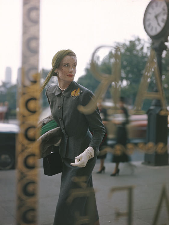 Wenda Parkinson wearing a grey flannel suit and lime-green cap, 1949