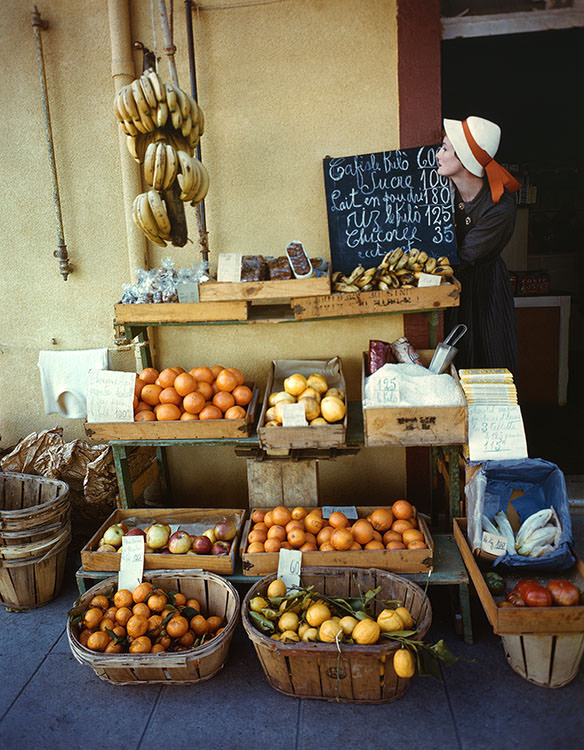 Wenda Parkinson poses at a fruit stall in the South of France, 1949