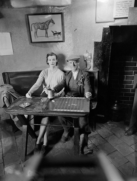 Wenda Parkinson wearing a cashmere twin-set from Women’s Home Industries. In the public bar at Hobnails Inn, Little Washbourne, Gloucestershire, 1951