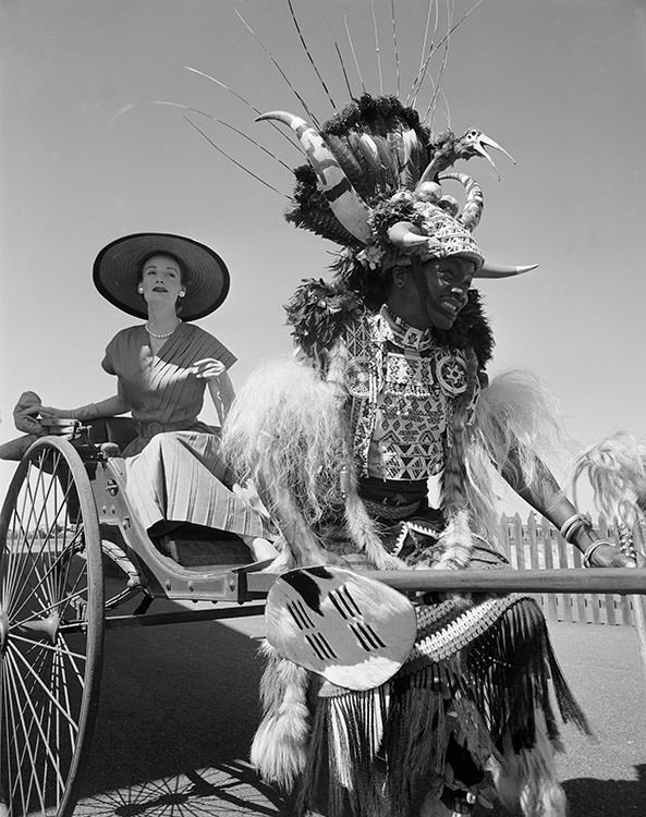 Wenda Parkinson in a rickshaw, dress by Roter, 1956