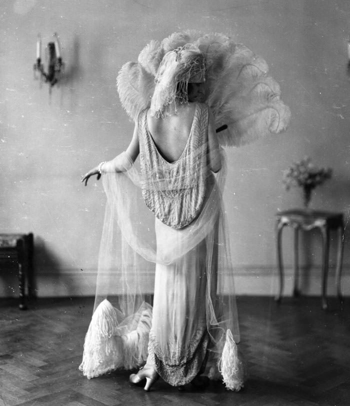 A woman wearing a cloche hat decorated with flowers, 1927