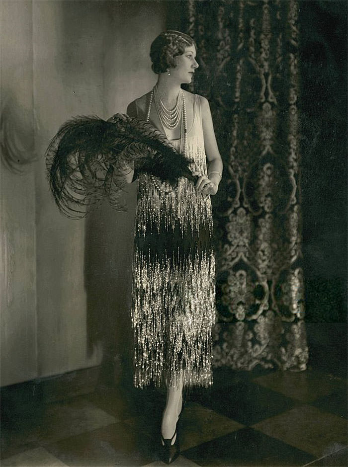 Alden gay wearing pearls and a gown of black and white georgette crepe by Chanel, 1924