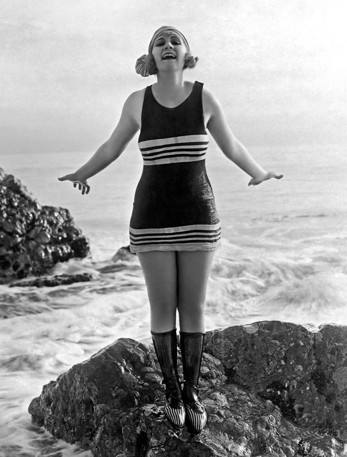 A Flapper in her Bathing Suit on a Rock at The Beach, Los Angeles, 1922