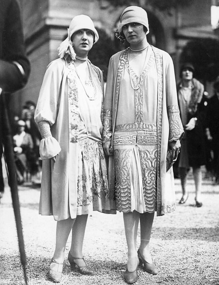 Two Fashionable Women, Wearing Twenties Drop-waist Dresses and Cloche Hats, 1925