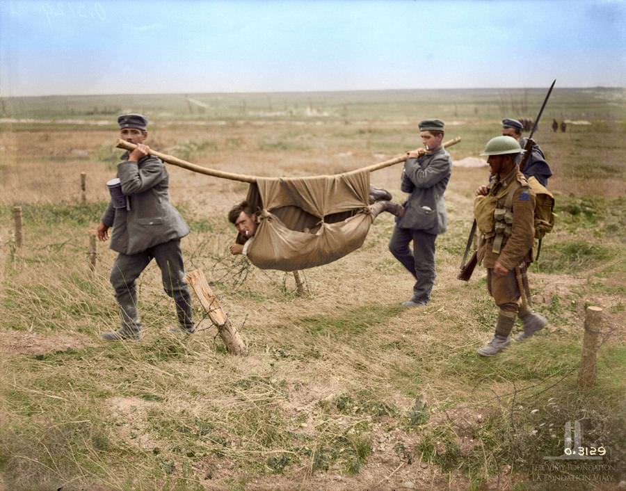 German prisoners carrying Canadian wounded advance east of Arras, August 1918