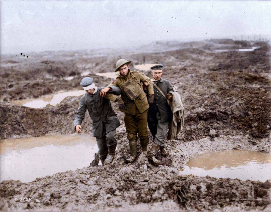 Canadian and German wounded help one another through the mud during the captured of passchendaele, November 1917