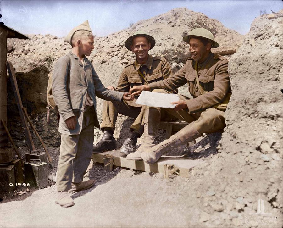 Tom Longboat the Indian long distance runner buying a paper from a little french newspaper boy, jun 1917