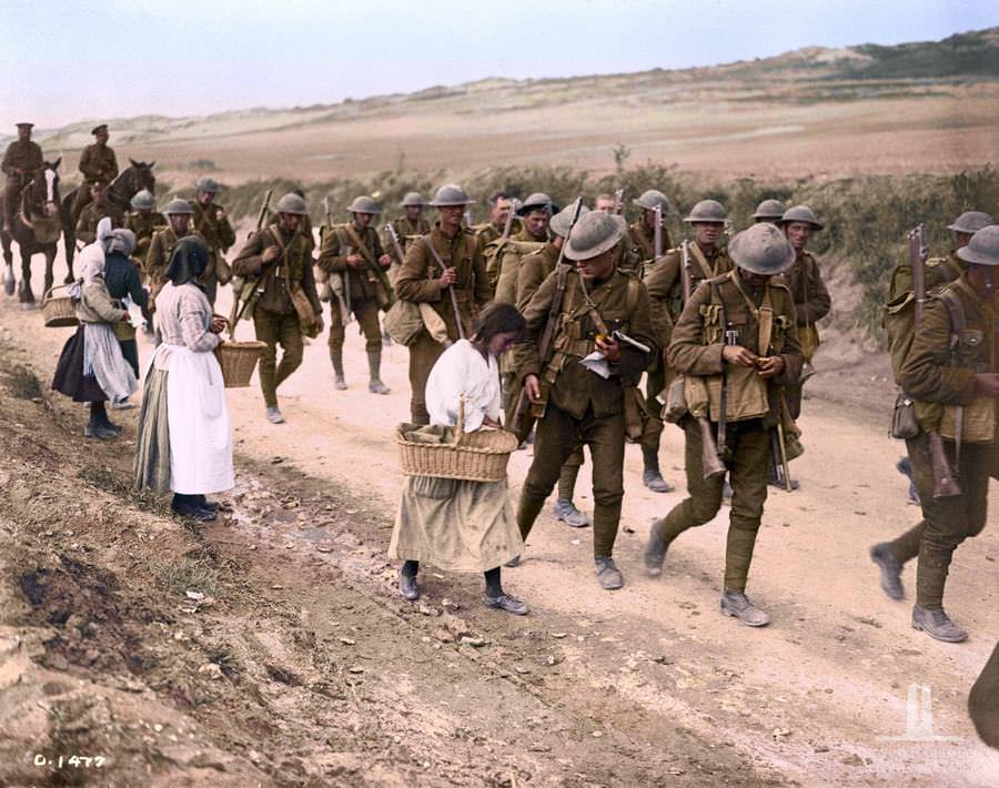 Women Selling oranges to Canadian troops on their return to camp, June 1917