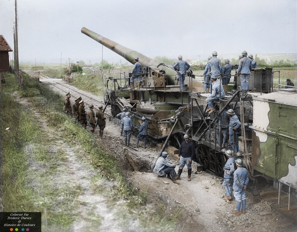 Canadian officers interested in a large French gun mounted on railroad, October 1917